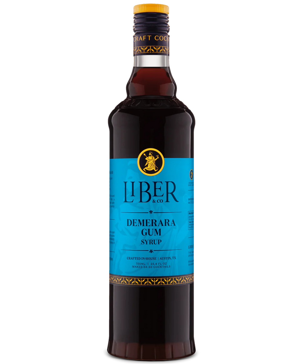 Front view of a dark brown bottle with a vibrant blue label and a yellow emblem, against a white background.