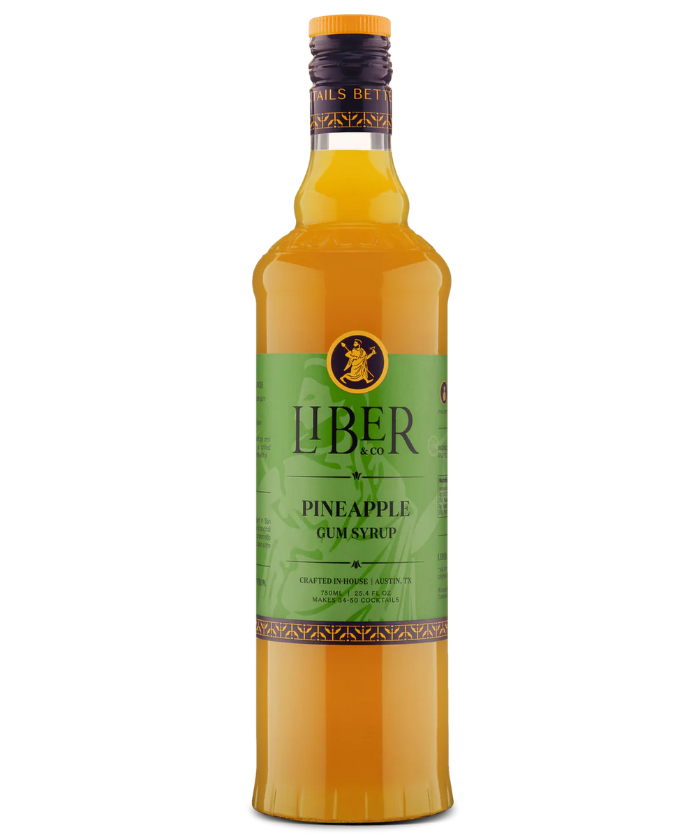 Glass bottle with green Liber label and yellow liquid, featuring pineapple flavor for beverages.
