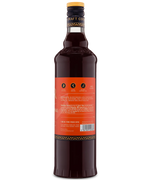 Back view of a tall glass bottle with a red label and dark liquid, ideal for gourmet drinks or cocktails.