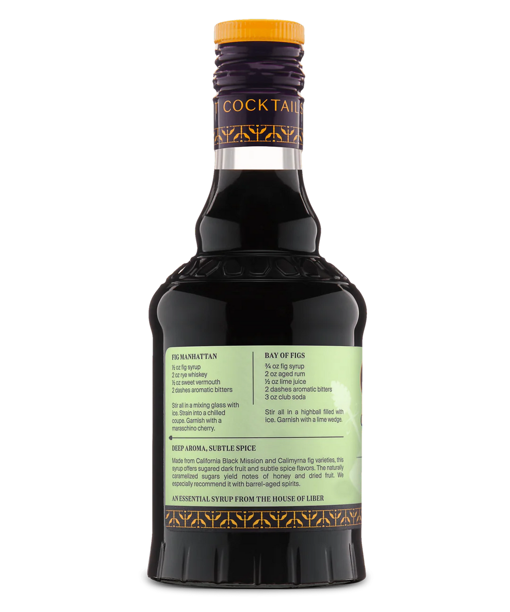 Back view of a glass bottle with a pale green label and dark liquid, perfect for cocktail mixes.