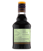 Back view of a glass bottle with a pale green label and dark liquid, perfect for cocktail mixes.