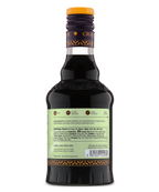 Back view of a glass bottle with pale green label and dark liquid, ideal for cocktails or desserts.