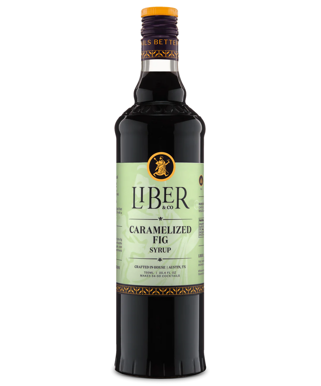 Front view of a glass bottle with Liber branding, pale green label, and dark liquid, featuring caramelized fig syrup.