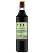 Side view of a tall glass bottle with pale green label and dark liquid, suitable for gourmet beverages.