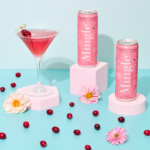 Mingle Mocktails cans with a pink cranberry martini, surrounded by cranberries and flowers on pastel backdrop.